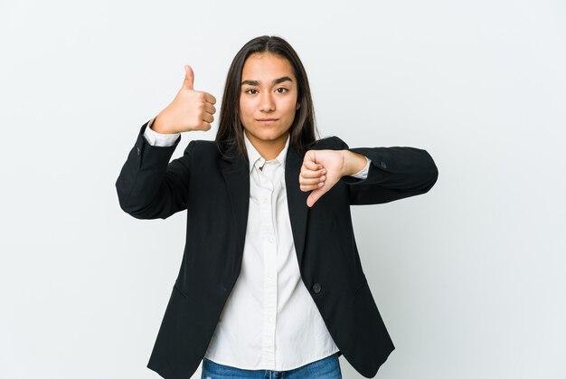 Young asian bussines woman isolated on white showing thumbs up and thumbs down, difficult choose concept