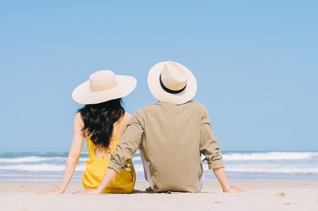 Young Asian couple enjoying summer vacation on the beach