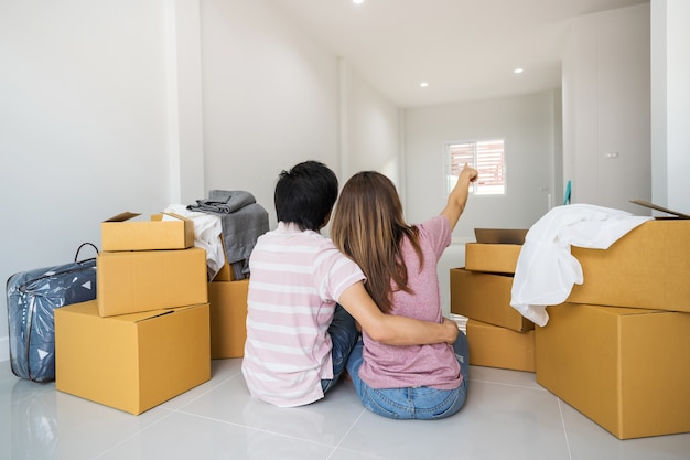 Young asian couple moving into new home together