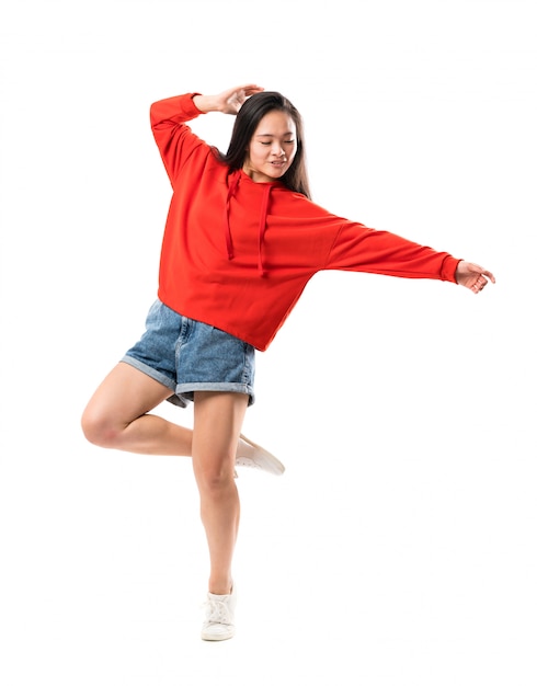 Young asian dancer over isolated white wall