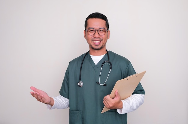 Young Asian doctor smiling with arm open while holding a writing pad