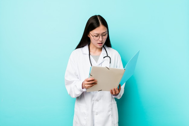 Young asian doctor woman holding a folder