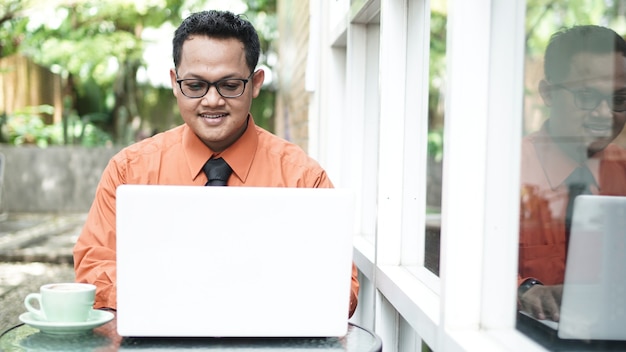 Young Asian entrepreneurs looking at laptop