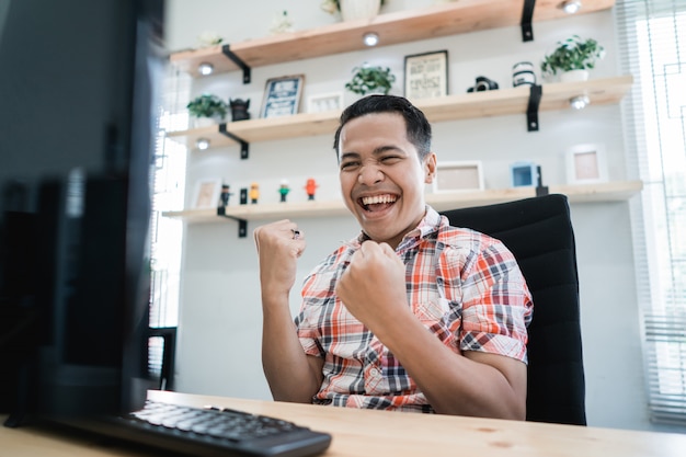 Young asian excited while working in the office