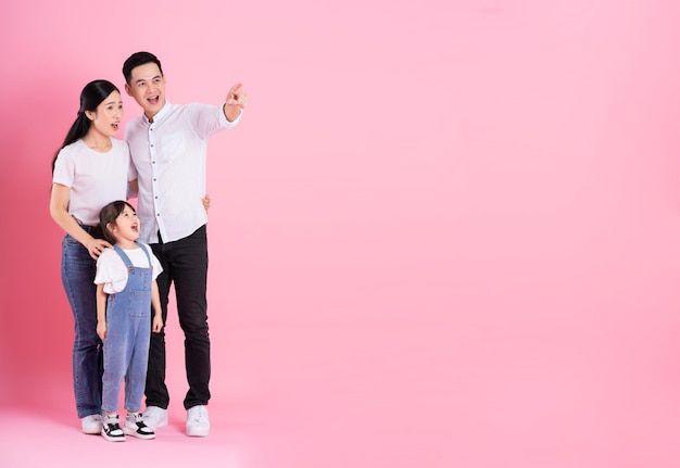 Young asian family image isolated on pink background