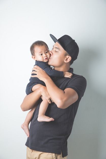 Young Asian father holding his adorable baby