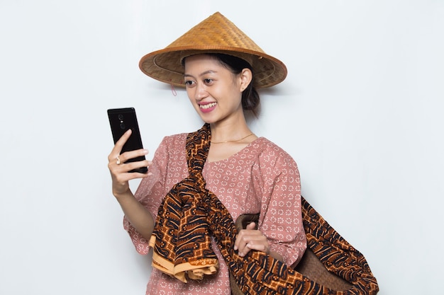 Young asian female farmer using mobile phone on white background