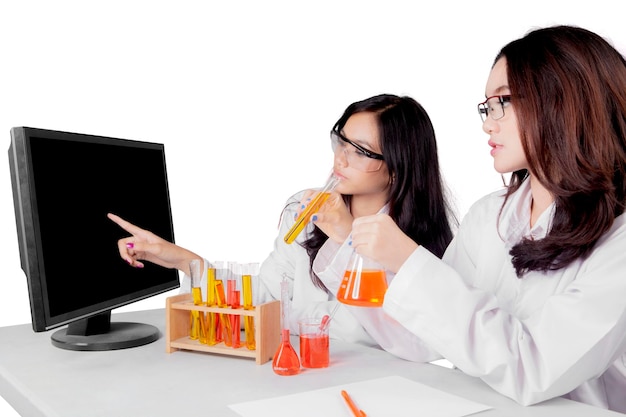 Young Asian female scientists doing research isolated over white background