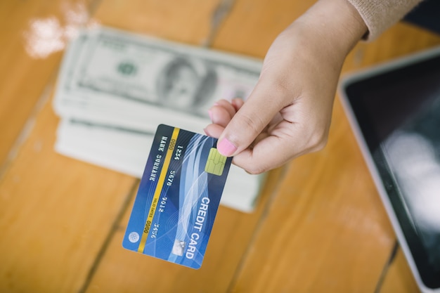 Photo young asian female was decided to pay with credit cards instead of cash. in coffee shop