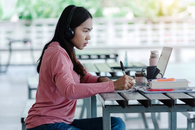 a young asian freelance businesswoman working  on laptop at home during covid-19  pandemic.. an adult learner studying online at homet. stock photo