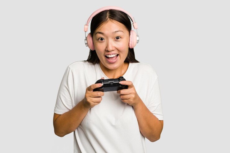 Photo アジアの若いゲーマー女性がゲームコントローラーとヘッドフォンで遊んでいます