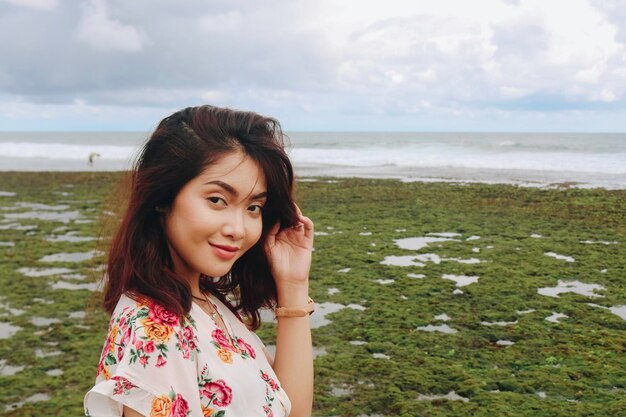 A young Asian girl on the beach is smiling at the camera at Gunungkidul Indonesia