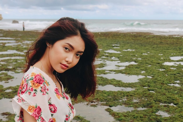 A young Asian girl on the beach is smiling at the camera at Gunungkidul Indonesia