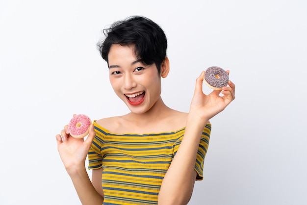 Young Asian girl holding donuts with happy expression