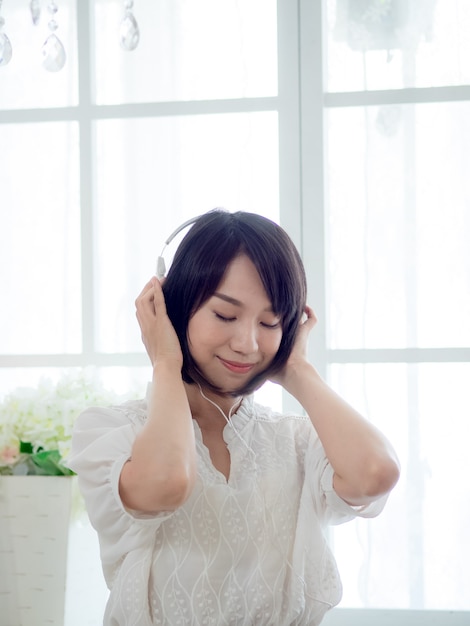 Young asian girl listening to the music at home