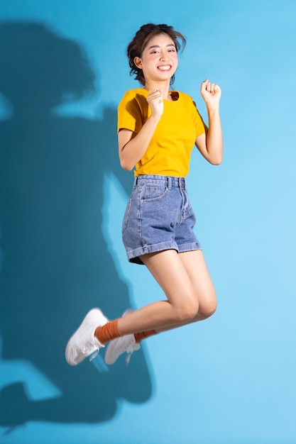 Young Asian girl posing on blue