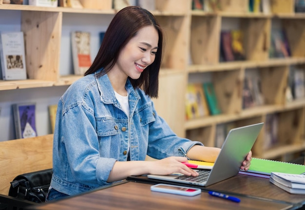 Young asian girl studying at library