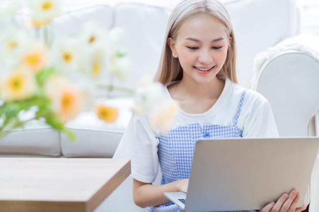 Young Asian girl using laptop at home