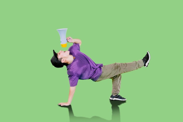 Young asian guy breakdancing with megaphone