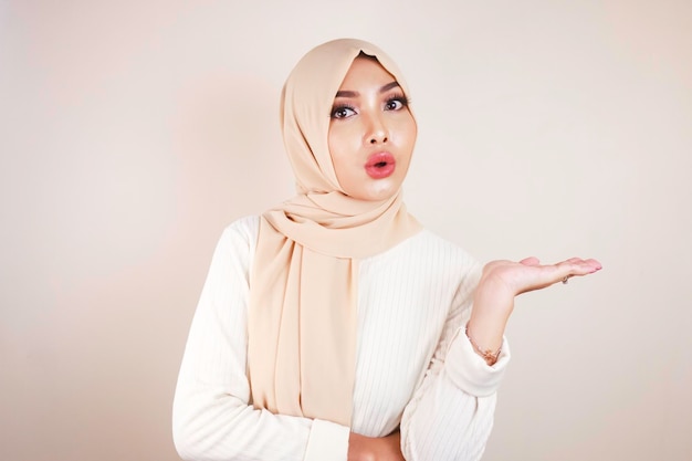 Young Asian Islam woman wearing headscarf is shocked