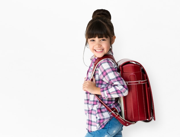 Young asian kid student with a backpack studio portrait