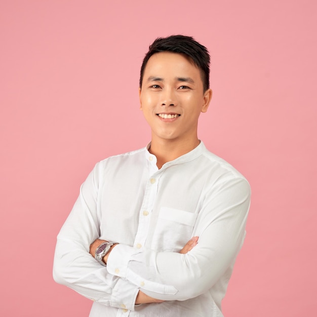 Young Asian male smiling and laughing with arms crossed