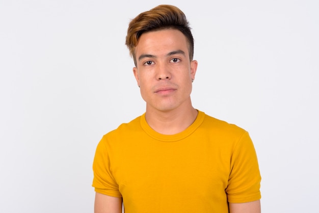  young Asian man against white wall