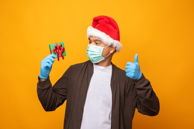 Young Asian man on Christmas day holding a gift box