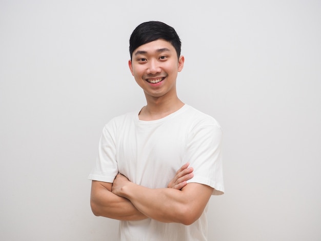 Young asian man cross arm white shirt with happy smile on his face feel confident on white isolate