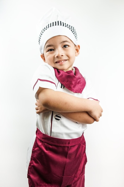 Young Asian man dressed as a chef preparing to cook Portrait of a happy cute male child cook