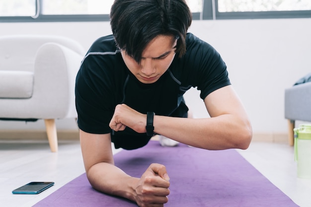 Young asian man exercising at home