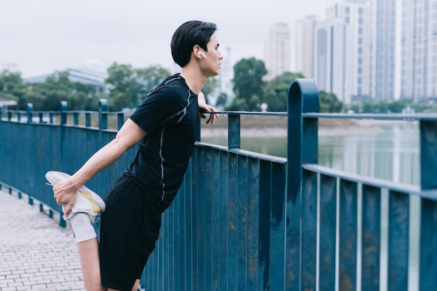 Young Asian man exercising in park