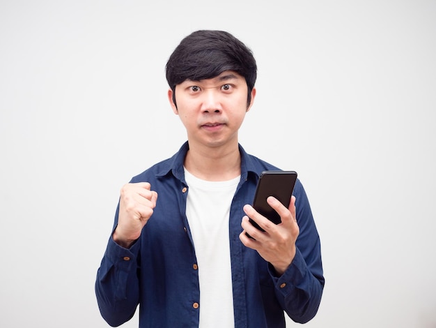 Young asian man feeling angry and show fist nad mobile phone up white isolated