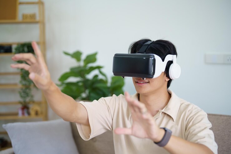 Photo 仮想現実を身に着けvr体験中に空気に触れる若いアジア人ゲーマー 未来のホームテクノロジープレイヤー 趣味 遊び心のコンセプト