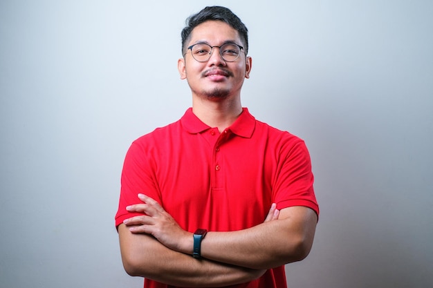 Young asian man happy face smiling with crossed arms looking at the camera positive person