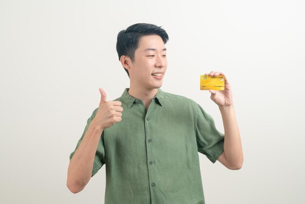 Young Asian man holding credit card