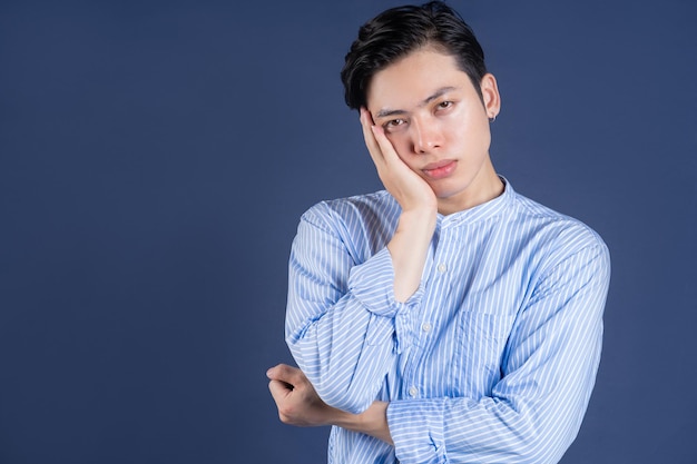 Young Asian man posing on background