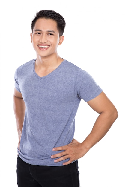 Young asian man posing hands on the waist, smile to the camera