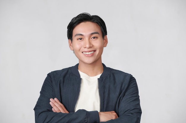 Young Asian man posing on white background