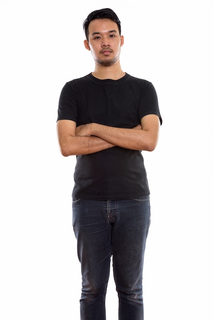  young Asian man standing with arms crossed