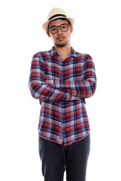  young Asian man standing with arms crossed