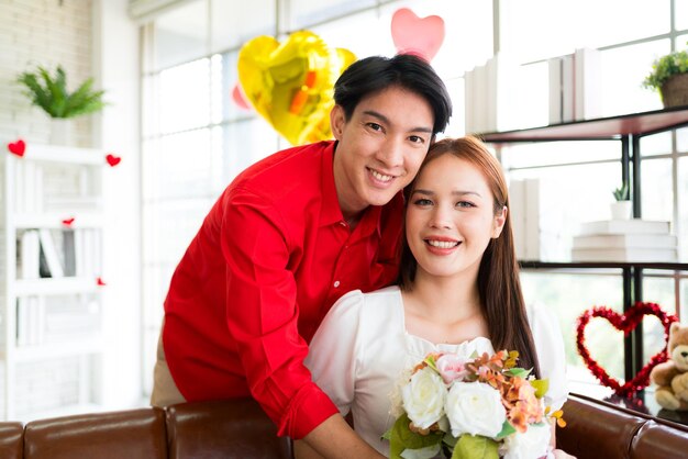 Foto un giovane asiatico ha sorpreso la sua ragazza regalandole un bouquet di rose per il suo anniversario