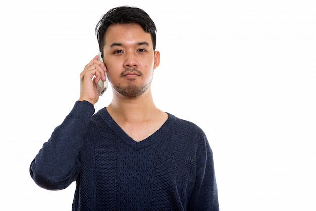 young Asian man talking on mobile phone