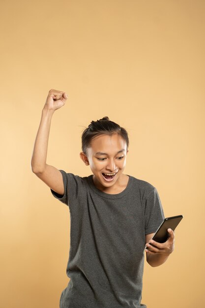 Young asian man using mobile phone at studio