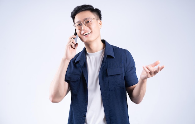 Young Asian man using smartphone on background