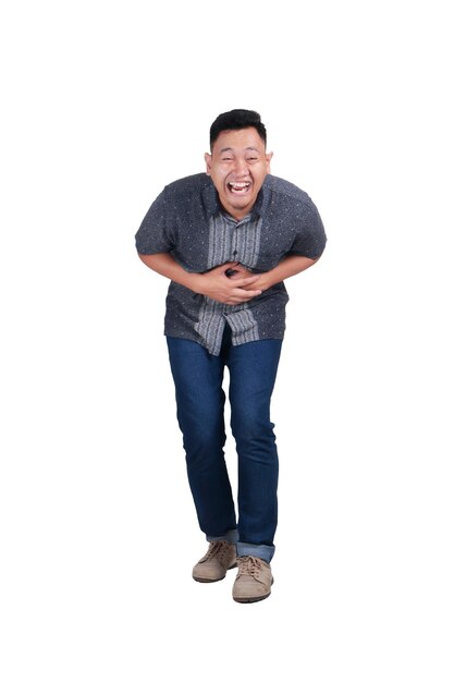 Photo young asian man wearing blue jeans and batik shirt laughing hard gesture