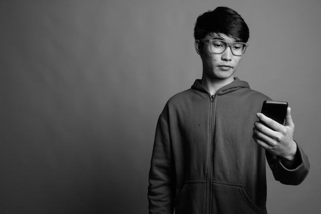 Young Asian man wearing jacket with eyeglasses