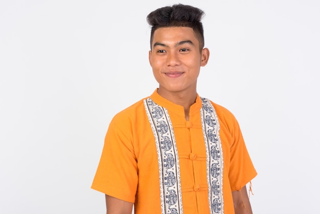  young Asian man wearing traditional clothes against white wall