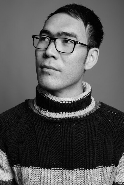 Young Asian man wearing turtleneck sweater and eyeglasses