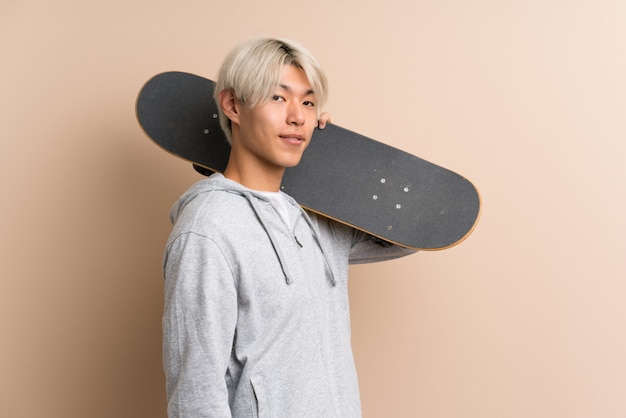 Young asian man with skate